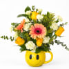 Mixed bouquet in a yellow smiley-face mug vase