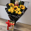 Bouquet of yellow roses and sunflowers with a teddy bear and chocolates