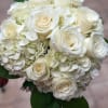 White hydrangea with creamy white roses and a touch of green