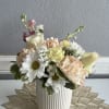Pastel flower arrangement in a ribbed white vase