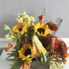 sunflowers with other fall flowers and a real pumpkin 