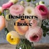 Bouquet of pink, white, and yellow ranunculus in a glass vase