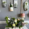 Succulent and rose arrangement in a white wooden box