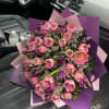 Large bouquet of pink and purple tulips wrapped in pink and purple paper
