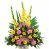 Yellow and pink floral arrangement in a square vase