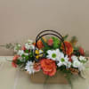 Bright orange roses paired with cheerful white daisies and carnations give this