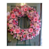 Pink floral wreath on a green easel stand