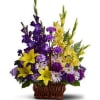 Basket arrangement of purple and yellow flowers