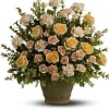 Arrangement of pale roses and carnations in a brown pot