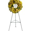 Yellow floral wreath on a black standing easel