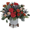 Arrangement of red and orange roses in a white vase