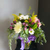 Mixed bouquet in a glass vase with white, pink, and yellow flowers