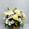 Basket arrangement of pale yellow roses and white daisies