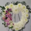 Heart-shaped floral wreath with white chrysanthemums and pink-purple roses