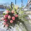 Pink roses and white lilies in a large standing arrangement