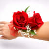 

A timeless corsage featuring two premium red roses accented with fresh greenery