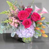 Vivid hot-pink roses crown a cloud of lavender hydrangeas in this joyful