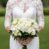 Bride holding a white rose and hydrangea bouquet