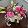 Pink roses and white lilies arranged in a low bouquet