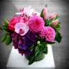 Pink and purple floral arrangement in a glass vase