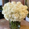 White rose bouquet in a clear glass vase
