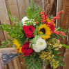 Bouquet of red roses, sunflowers, and white mums with berry accents