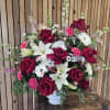 Medium sized arrangement with bold reds and pink.  Set inside a