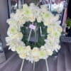 White floral wreath on a standing easel