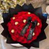 Red rose bouquet with gold-wrapped chocolates and black ribbon