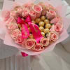 Pink rose bouquet with gold-wrapped chocolates and a satin ribbon