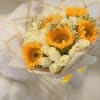 Bouquet of sunflowers and white roses wrapped in cream paper