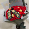 Bouquet of red roses with gold-wrapped chocolates and a black ribbon