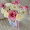 Pink and white bouquet with roses, chrysanthemums, and gerbera daisies in a white container
