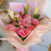 Pink rose bouquet with white lilies wrapped in pale pink paper