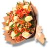 Bouquet of orange and cream flowers wrapped in brown paper with a ribbon