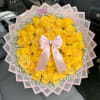 Yellow rose bouquet with a pink ribbon and clear wrap in a car seat