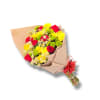 Bouquet of red roses, yellow blooms, and green button mums wrapped in beige paper