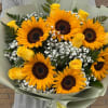 Bouquet of sunflowers and yellow roses with baby's breath