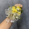 Yellow spray roses with gold ribbon and gold accents wrist corsage with
