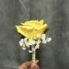 Yellow rose boutonni&egrave;re with gold ribbon 