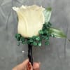 White rose with emerald green baby breath boutonni&egrave;re wrapped with black ribbon