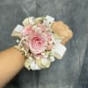 Pink spray roses round corsage with white, gold ribbon and gold accents