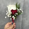 White rose and deep red mini carnation boutonni&egrave;re with baby's breath and