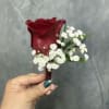 Deep red rose with white filler and green leaves beautifully wrapped 