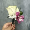 Creamy white rose with plum alstroemeria and delicate white fillers, wrapped in