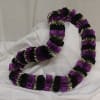 Purple and black ribbon lei draped in a loop