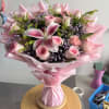 Pink bouquet with roses, lilies, and carnations wrapped in pink paper