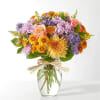 Soft lavender and peach stems are expertly arranged with deeper shades to