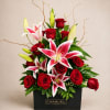 Velvety red roses meet pink-and-white stargazer lilies in a compact, modern gift-box