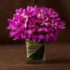 Purple orchid bouquet in a clear square vase